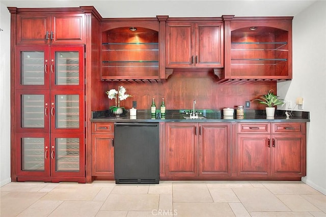 bar with wet bar, a sink, and baseboards