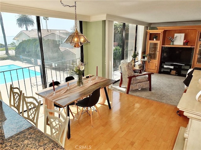 2601 E Ocean Blvd Unit 205, Long Beach, CA 90803 - dining area with ornamental molding, wood finished floors, and floor to ceiling windows