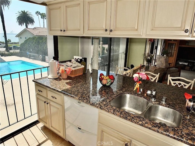 2601 E Ocean Blvd Unit 205, Long Beach, CA 90803 - kitchen featuring cream cabinets, a sink, and light tile patterned floors