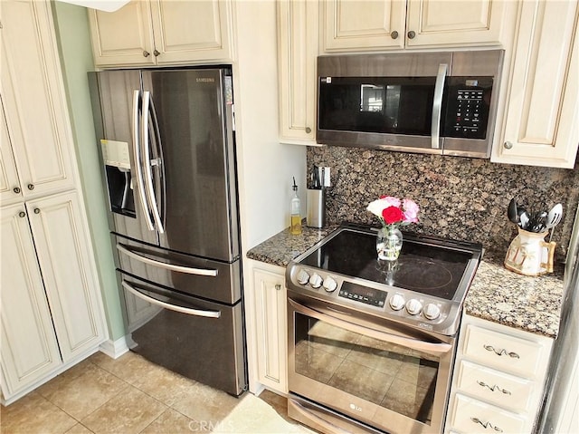 2601 E Ocean Blvd Unit 205, Long Beach, CA 90803 - kitchen with stainless steel appliances, cream cabinetry, backsplash, and stone counters