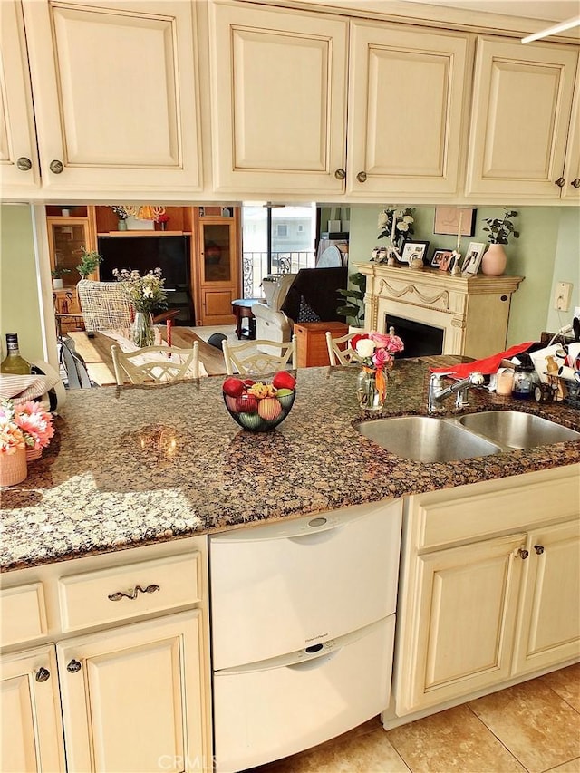 2601 E Ocean Blvd Unit 205, Long Beach, CA 90803 - kitchen featuring cream cabinetry, a sink, and dark stone countertops