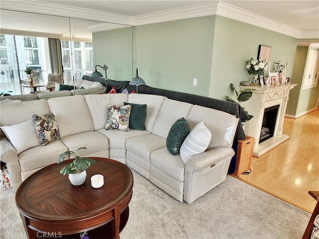 2601 E Ocean Blvd Unit 205, Long Beach, CA 90803 - living area with crown molding, wood finished floors, and a fireplace with raised hearth