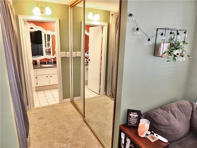2601 E Ocean Blvd Unit 205, Long Beach, CA 90803 - corridor with light colored carpet, light tile patterned flooring, and a sink