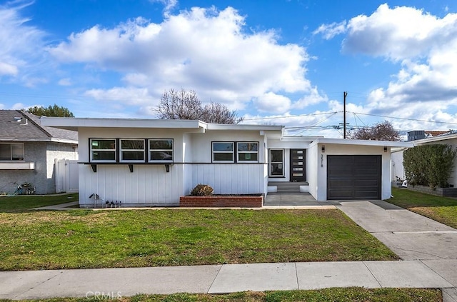 3518 Faust Ave, Long Beach, CA 90808 - view of front of home with an attached garage, a front lawn, and driveway