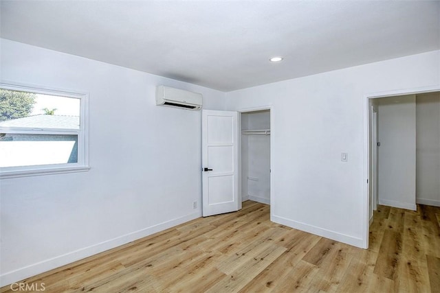 3518 Faust Ave, Long Beach, CA 90808 - unfurnished bedroom with a wall unit AC, light wood-type flooring, recessed lighting, and a closet