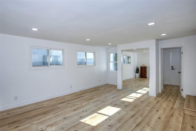 below grade area with recessed lighting, baseboards, and light wood-style flooring