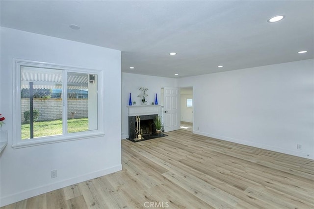 3518 Faust Ave, Long Beach, CA 90808 - unfurnished living room featuring light wood-style flooring, recessed lighting, and a fireplace