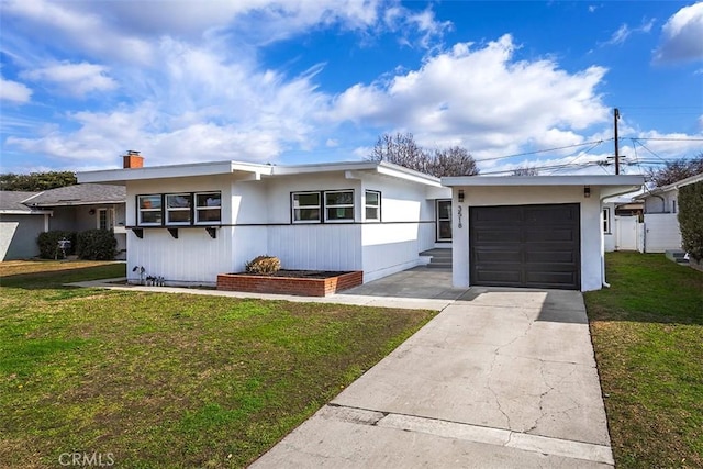 view of front facade with a garage, a front lawn, and driveway