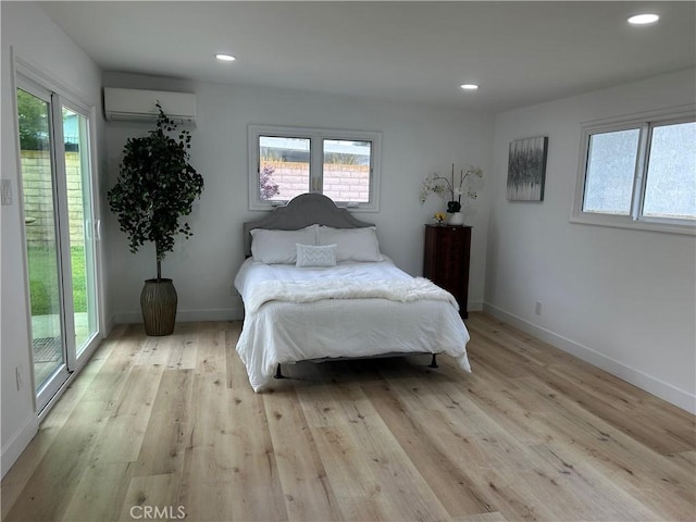 3518 Faust Ave, Long Beach, CA 90808 - bedroom with an AC wall unit, multiple windows, light wood-style flooring, and recessed lighting