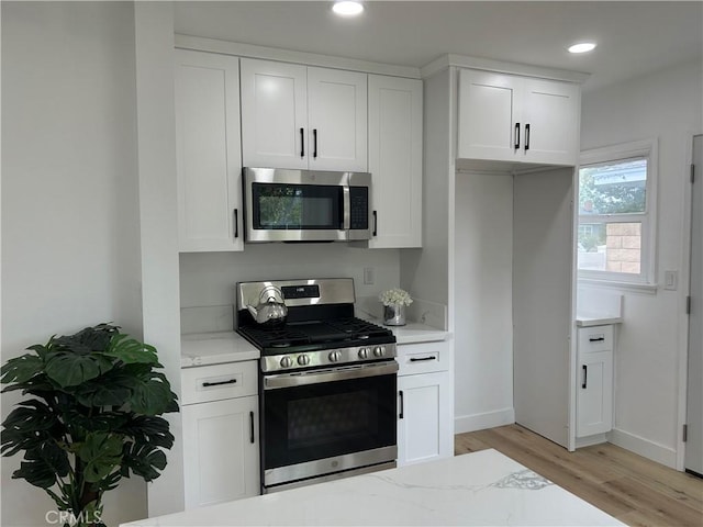 kitchen with light wood-style floors, stainless steel appliances, recessed lighting, and white cabinetry