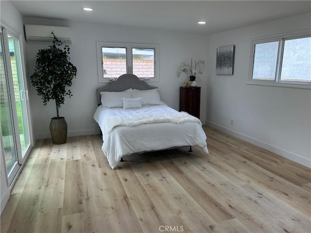 3518 Faust Ave, Long Beach, CA 90808 - bedroom with a wall mounted air conditioner, light wood-style flooring, and recessed lighting