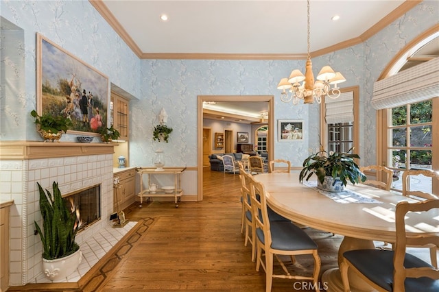 4537 Ellenboro Way, Woodland Hills, CA 91364 - dining area with crown molding, light wood-type flooring, a chandelier, a fireplace, and baseboards
