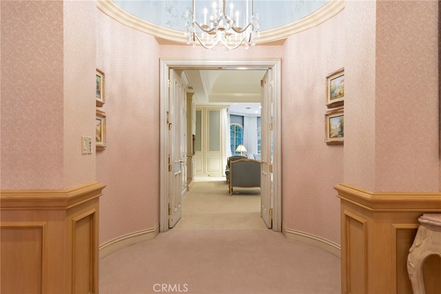 4537 Ellenboro Way, Woodland Hills, CA 91364 - corridor with light colored carpet, a chandelier, crown molding, wallpapered walls, and baseboards
