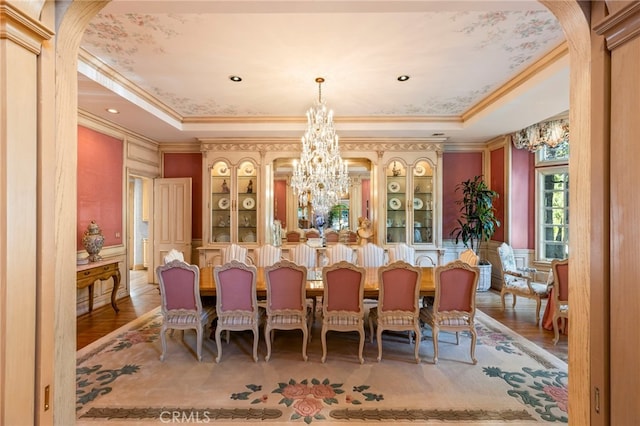 4537 Ellenboro Way, Woodland Hills, CA 91364 - dining area featuring a chandelier, ornamental molding, a tray ceiling, arched walkways, and wood finished floors