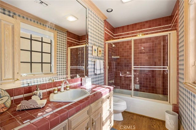 4537 Ellenboro Way, Woodland Hills, CA 91364 - bathroom with wood finished floors, toilet, vanity, combined bath / shower with glass door, and wallpapered walls