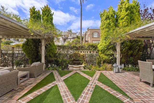 view of yard featuring outdoor lounge area, a pergola, fence, and a patio