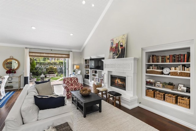 living area with baseboards, a warm lit fireplace, wood finished floors, and ornamental molding