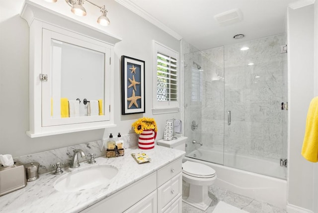 full bath with toilet, vanity, ornamental molding, and bath / shower combo with glass door