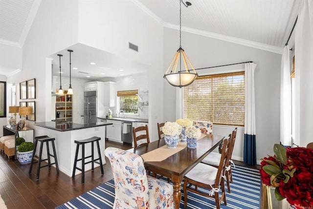 dining room with high vaulted ceiling, visible vents, crown molding, and dark wood-type flooring