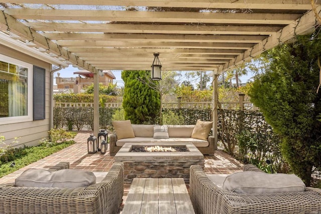 view of patio / terrace featuring a fire pit, fence, and a pergola
