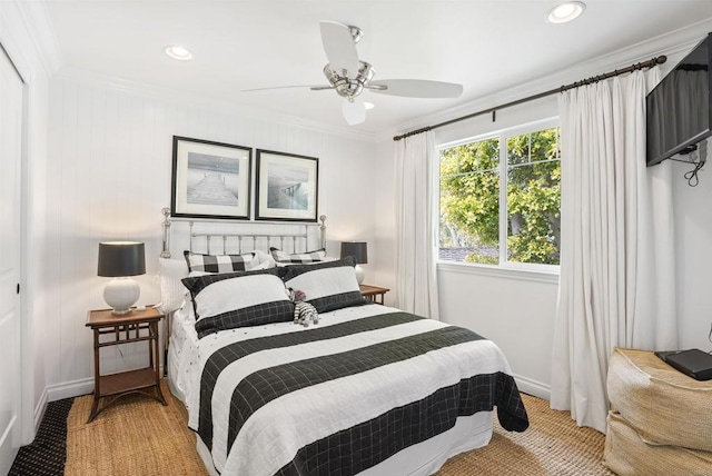bedroom featuring light colored carpet, crown molding, baseboards, and a ceiling fan