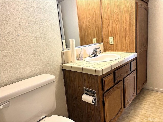 19238 Olive Way, Apple Valley, CA 92308 - half bath featuring baseboards, a textured wall, toilet, and vanity