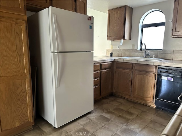19238 Olive Way, Apple Valley, CA 92308 - kitchen featuring tile counters, a sink, black dishwasher, and freestanding refrigerator