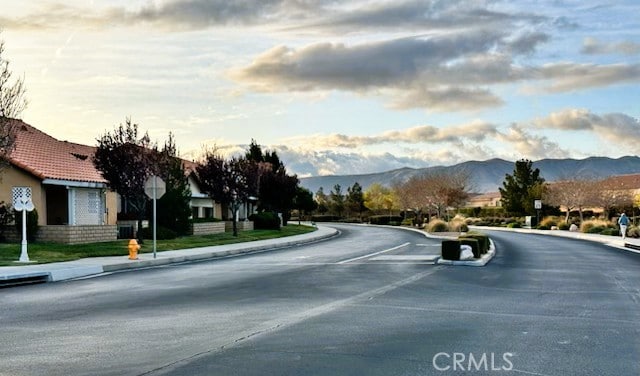 19238 Olive Way, Apple Valley, CA 92308 - view of road with sidewalks, a mountain view, traffic signs, and curbs