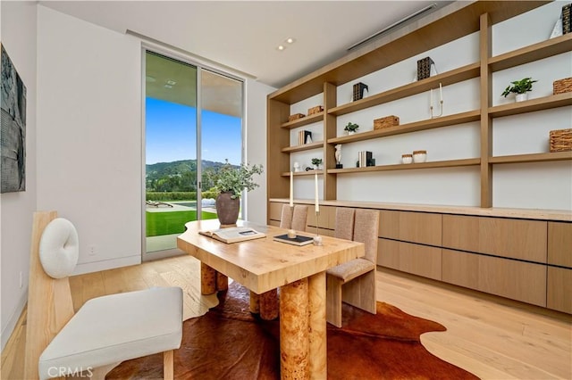 office area with floor to ceiling windows, baseboards, light wood-style floors, and recessed lighting