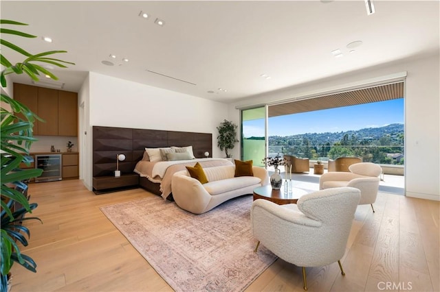 bedroom featuring access to outside, recessed lighting, wine cooler, and light wood-type flooring