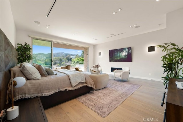 bedroom with recessed lighting, baseboards, and wood finished floors