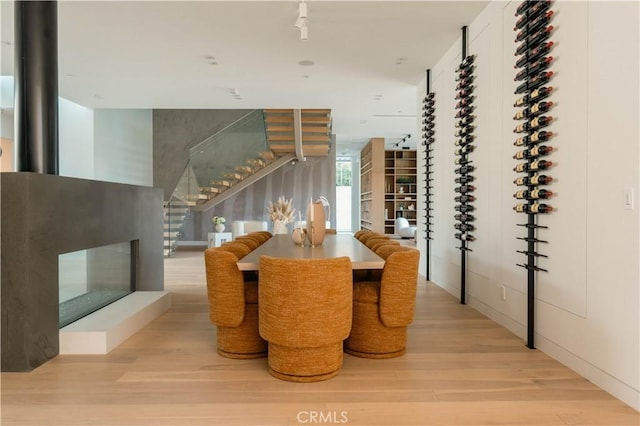 dining space with stairs and wood finished floors