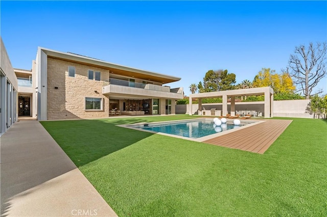 back of property featuring stone siding, fence, a yard, and a patio area