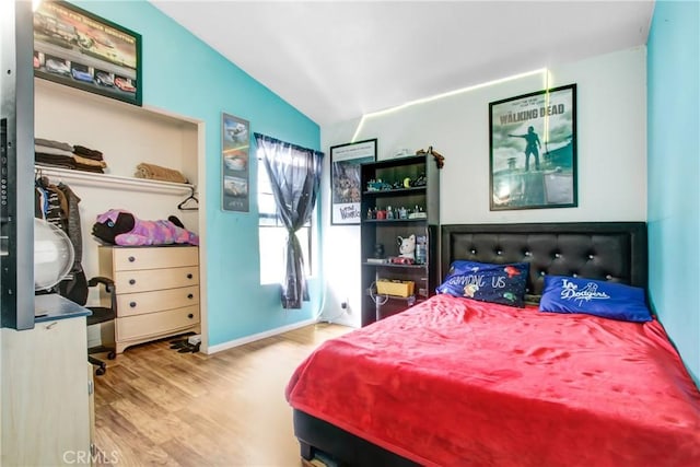 7801 Pinyon Ave, Fontana, CA 92336 - bedroom featuring baseboards, lofted ceiling, and wood finished floors