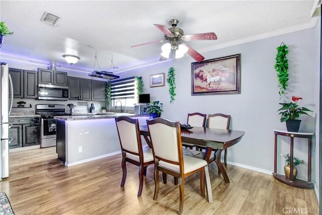7801 Pinyon Ave, Fontana, CA 92336 - dining area with crown molding, ceiling fan, visible vents, and light wood-type flooring