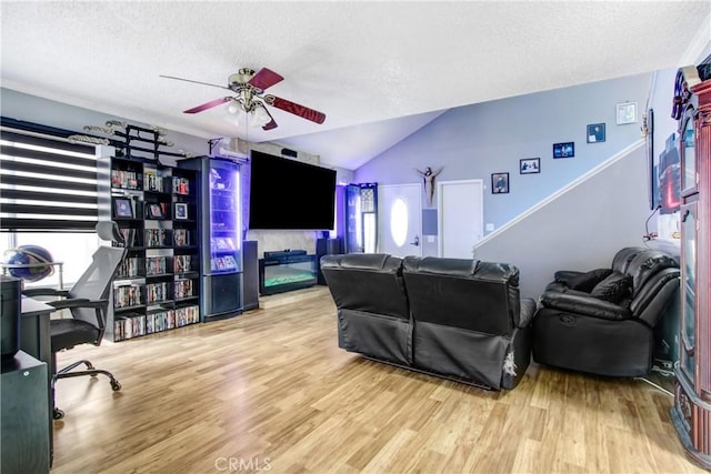 7801 Pinyon Ave, Fontana, CA 92336 - living area featuring a ceiling fan, a textured ceiling, vaulted ceiling, and wood finished floors
