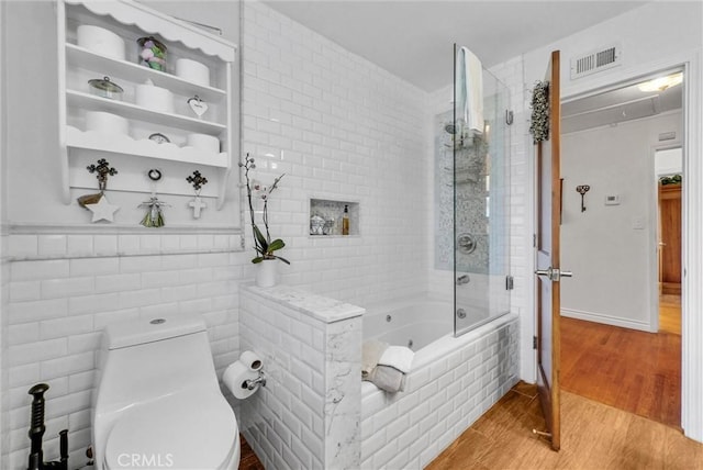 19903 E Rambling Rd, Covina, CA 91724 - full bath featuring toilet, wood finished floors, tiled shower / bath combo, and tile walls