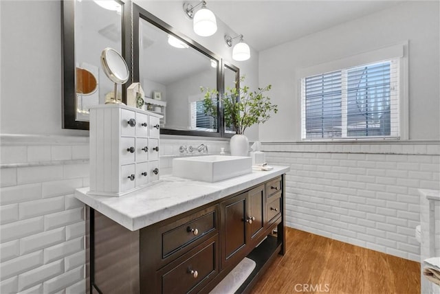 19903 E Rambling Rd, Covina, CA 91724 - bathroom with a wainscoted wall, wood finished floors, vanity, and tile walls