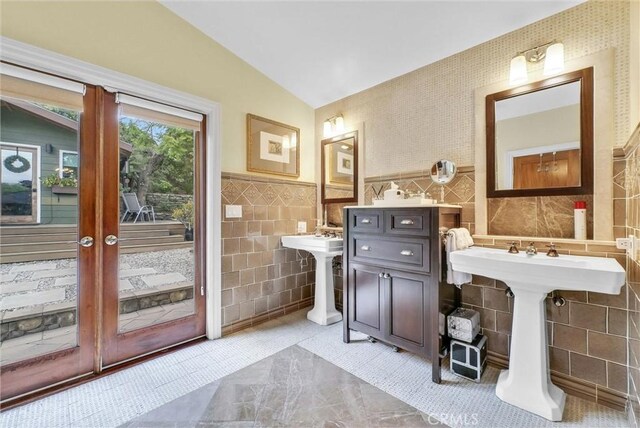 19903 E Rambling Rd, Covina, CA 91724 - bathroom with tile walls, lofted ceiling, a sink, and a wainscoted wall