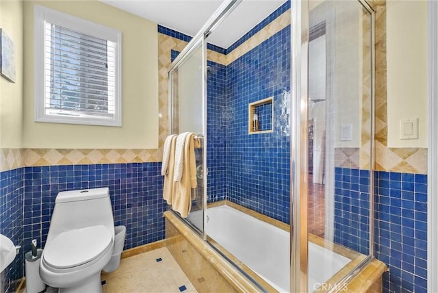 19903 E Rambling Rd, Covina, CA 91724 - bathroom with tile walls, toilet, tiled shower / bath combo, tile patterned floors, and a wainscoted wall
