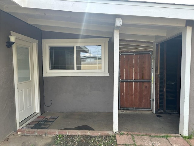 property entrance with stucco siding