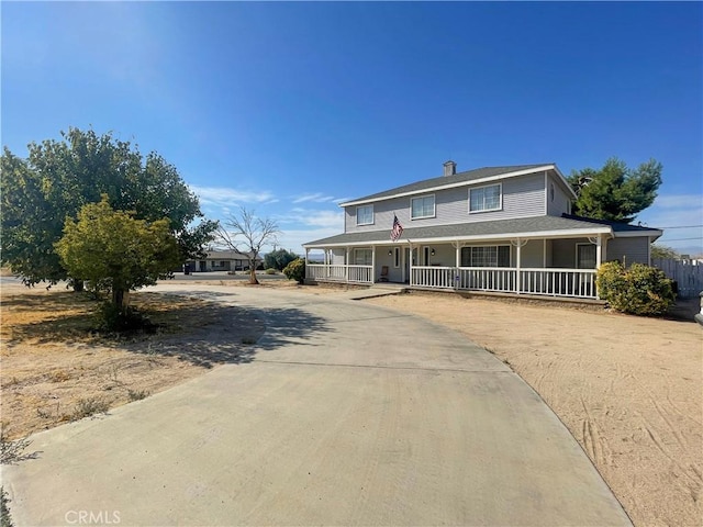 14610 Apple Valley Rd, Apple Valley, CA 92307 - country-style home featuring curved driveway, covered porch, and a chimney