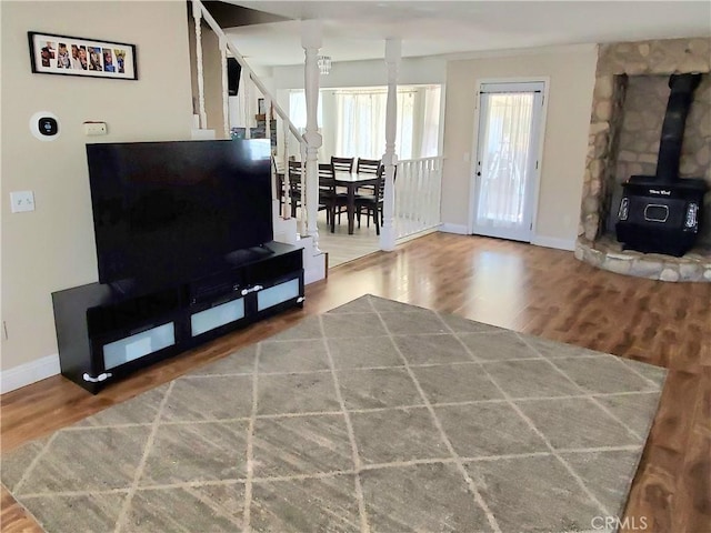 14610 Apple Valley Rd, Apple Valley, CA 92307 - living room with a wood stove, baseboards, and wood finished floors
