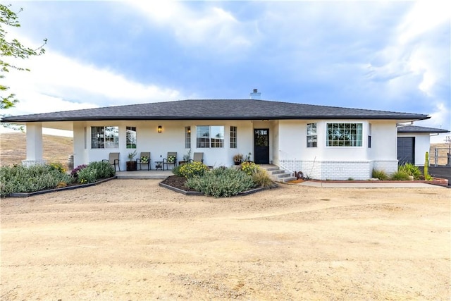 ranch-style home with brick siding and stucco siding