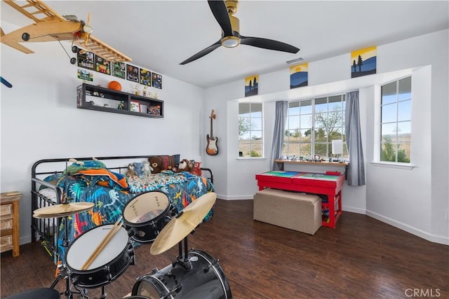bedroom featuring baseboards, ceiling fan, wood finished floors, and visible vents