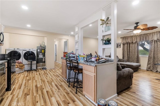9714 San Benito Ave, Gerber, CA 96035 - kitchen featuring open floor plan, light wood finished floors, water heater, washing machine and clothes dryer, and electric range