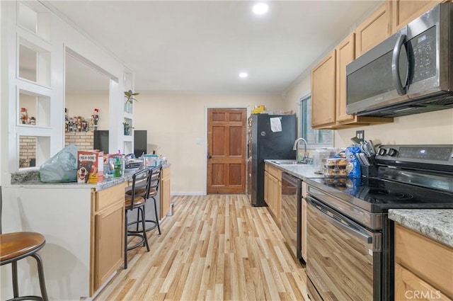 9714 San Benito Ave, Gerber, CA 96035 - kitchen featuring light brown cabinets, a sink, appliances with stainless steel finishes, recessed lighting, and light wood finished floors
