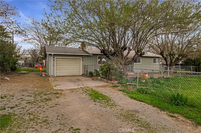 9714 San Benito Ave, Gerber, CA 96035 - exterior space featuring dirt driveway, fence, a garage, and a chimney
