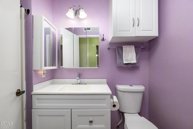 bathroom featuring toilet and vanity