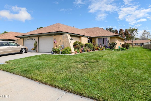 ranch-style home featuring a front yard, an attached garage, concrete driveway, and stucco siding